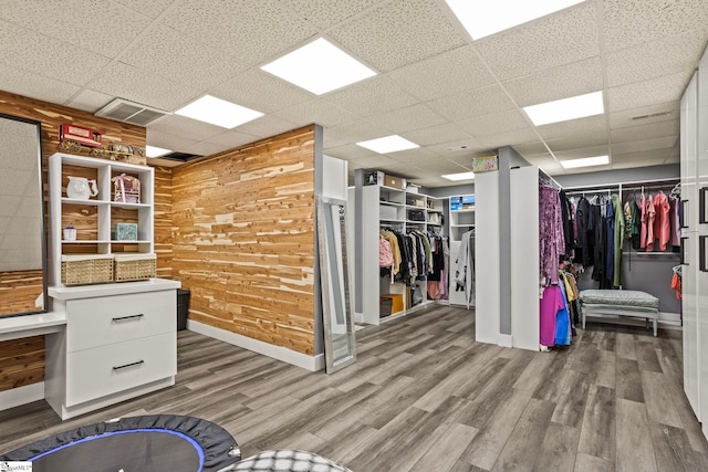 interior space featuring a paneled ceiling and wood finished floors