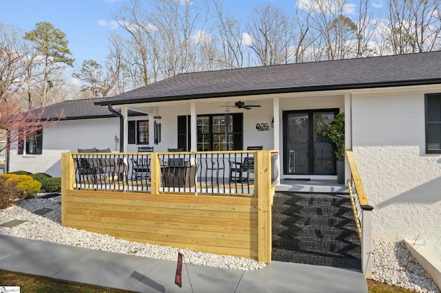 ranch-style house featuring a shingled roof, brick siding, and a porch