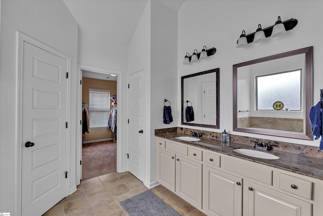 full bathroom with tile patterned floors, a closet, a sink, and double vanity