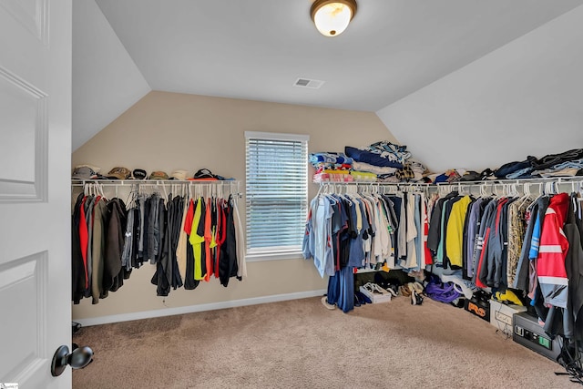 spacious closet featuring lofted ceiling, carpet flooring, and visible vents