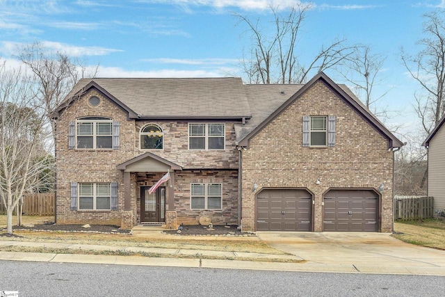 view of front of house featuring a garage, brick siding, fence, concrete driveway, and stone siding