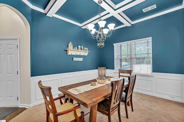 dining space with visible vents, coffered ceiling, arched walkways, a chandelier, and beam ceiling