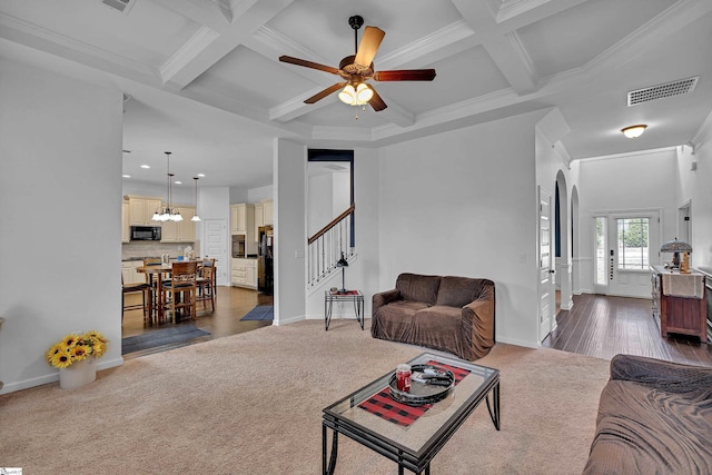 living area with baseboards, visible vents, coffered ceiling, stairway, and beam ceiling