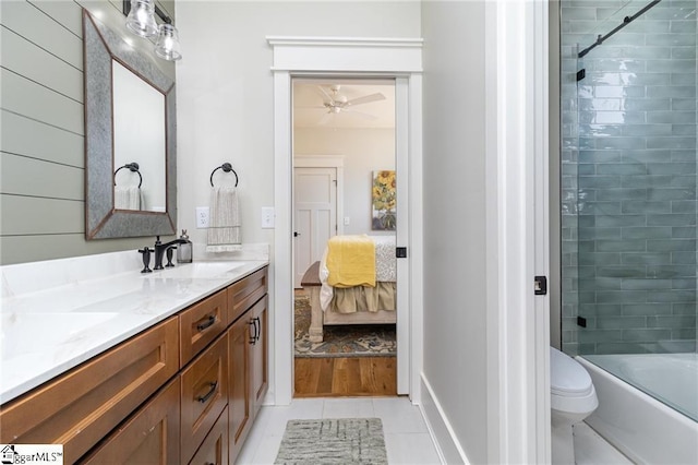 ensuite bathroom featuring double vanity, connected bathroom, toilet,  shower combination, and a sink