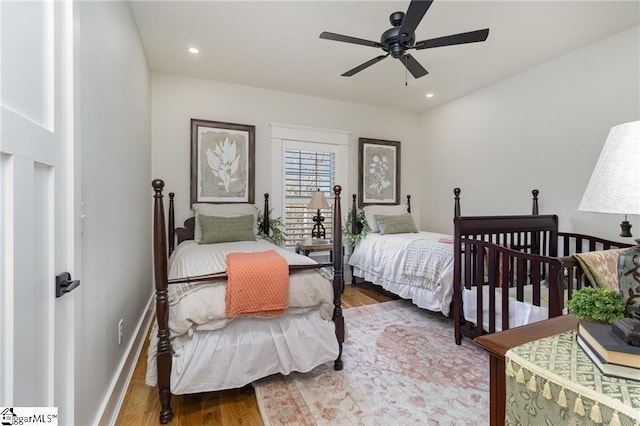 bedroom featuring a ceiling fan, baseboards, wood finished floors, and recessed lighting