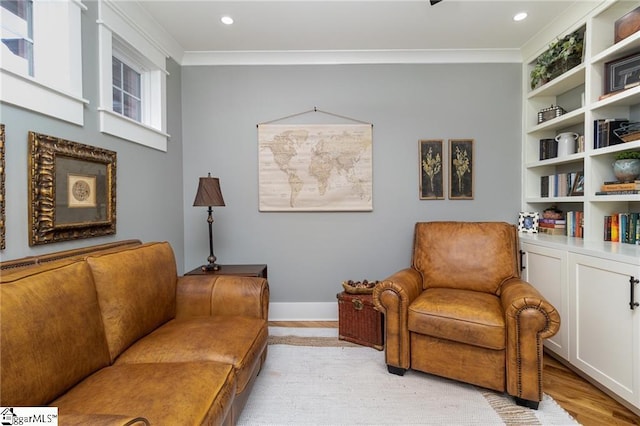 interior space with light wood finished floors, baseboards, crown molding, and recessed lighting