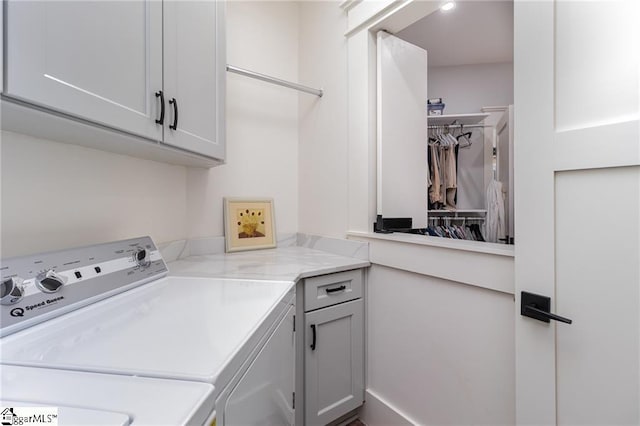 washroom featuring cabinet space and washer and dryer