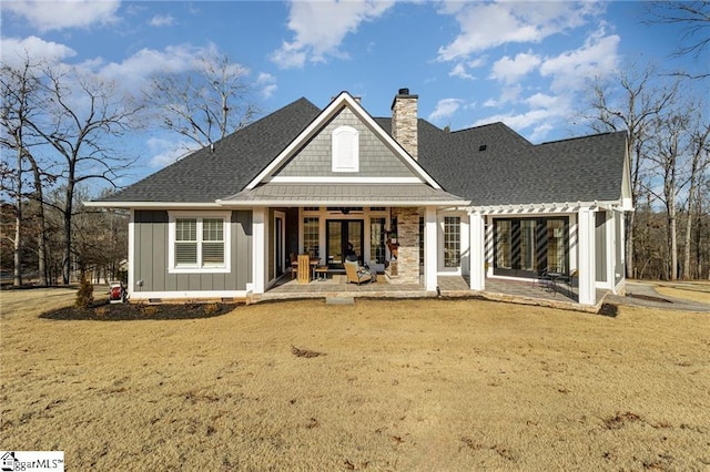 rear view of property featuring a shingled roof, a chimney, crawl space, french doors, and board and batten siding