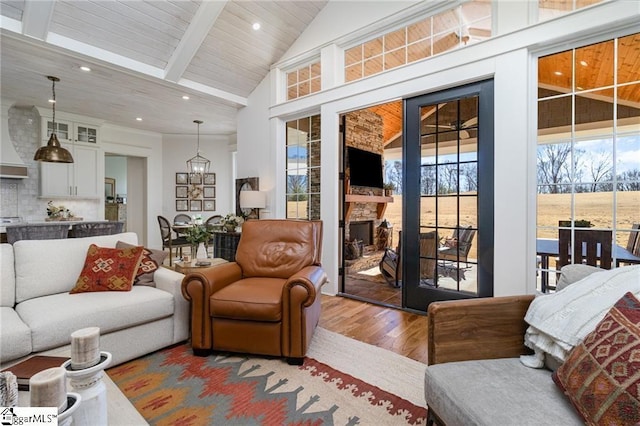 living room featuring wood finished floors, a fireplace, high vaulted ceiling, beam ceiling, and recessed lighting