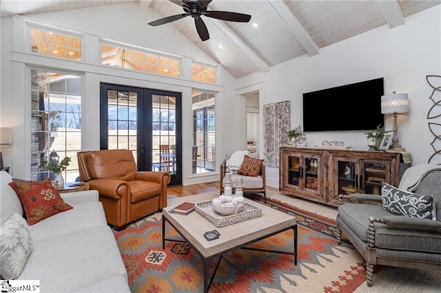 living room featuring a wealth of natural light, french doors, beam ceiling, and wood finished floors