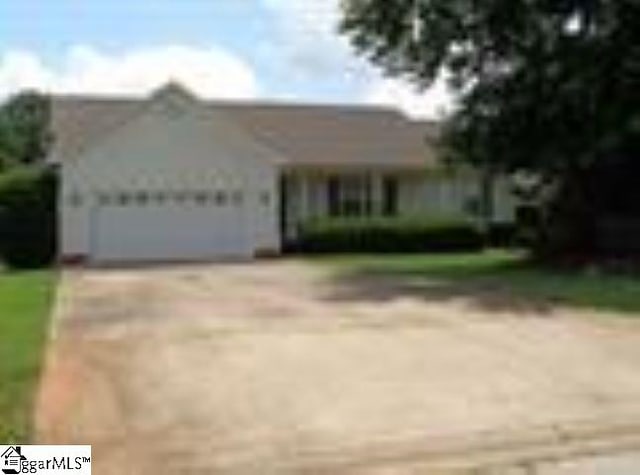 single story home featuring an attached garage and driveway