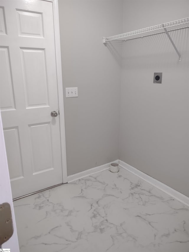 laundry area featuring laundry area, hookup for an electric dryer, marble finish floor, and baseboards