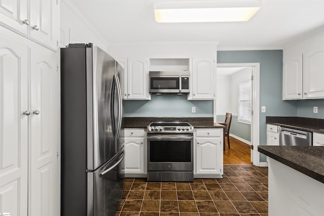 kitchen featuring crown molding, stainless steel appliances, baseboards, and white cabinets