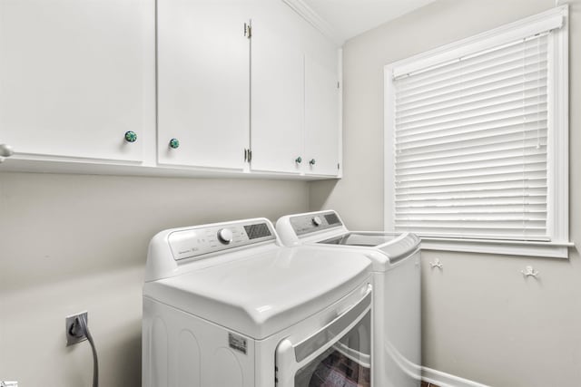 laundry area featuring cabinet space and separate washer and dryer