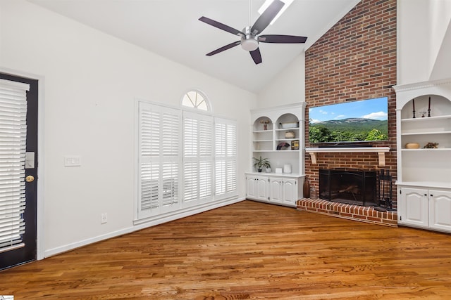 unfurnished living room with a fireplace, light wood finished floors, ceiling fan, high vaulted ceiling, and baseboards