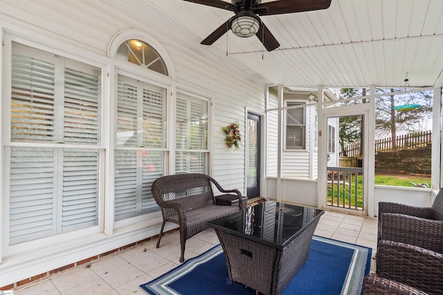 sunroom featuring ceiling fan