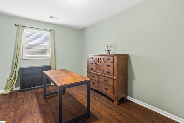 office featuring dark wood-style flooring, visible vents, and baseboards