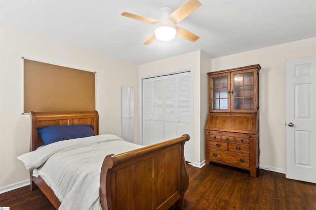 bedroom with a ceiling fan, baseboards, dark wood-type flooring, and a closet