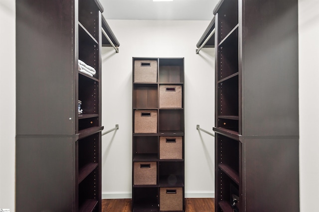 spacious closet with dark wood-style flooring