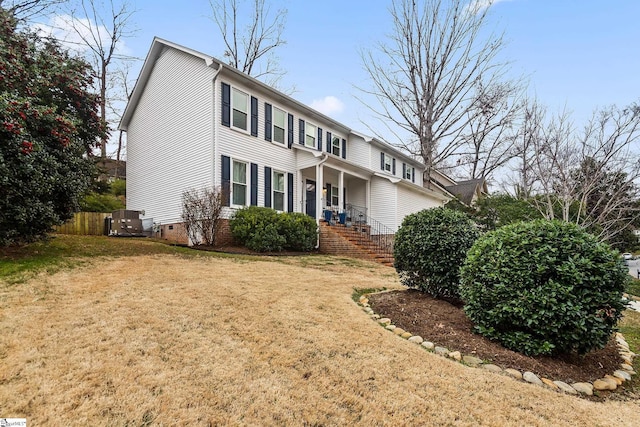 colonial-style house with crawl space, fence, cooling unit, a front lawn, and a porch