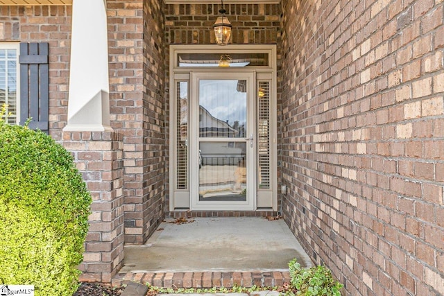 doorway to property with brick siding