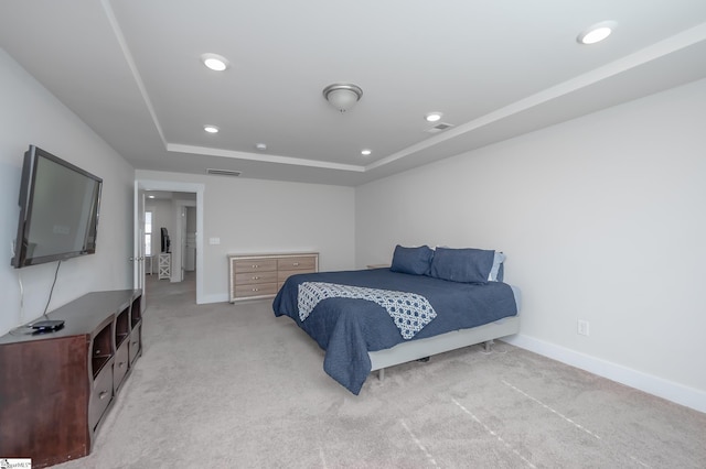 bedroom featuring recessed lighting, light colored carpet, visible vents, baseboards, and a tray ceiling