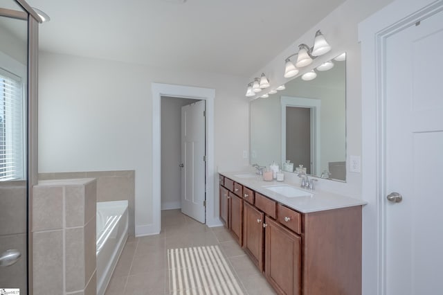 bathroom featuring a bath, double vanity, a sink, and tile patterned floors