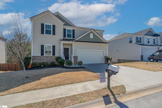 view of front of house featuring an attached garage, brick siding, fence, driveway, and board and batten siding