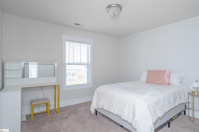 bedroom featuring baseboards, visible vents, and carpet flooring