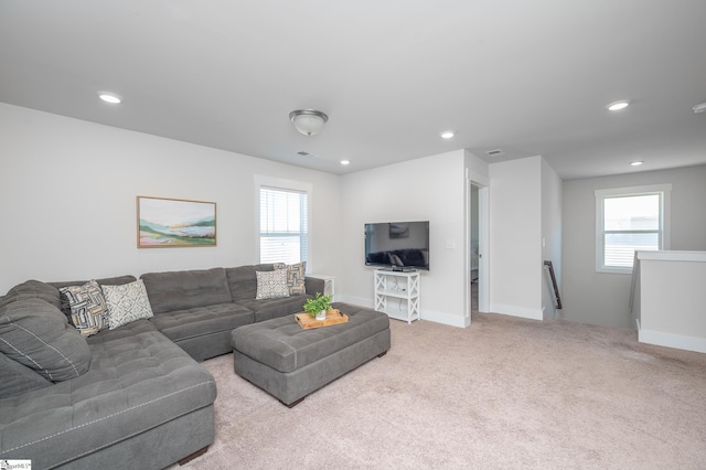 carpeted living area with recessed lighting, a healthy amount of sunlight, and baseboards