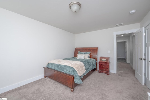 bedroom with light carpet, visible vents, and baseboards