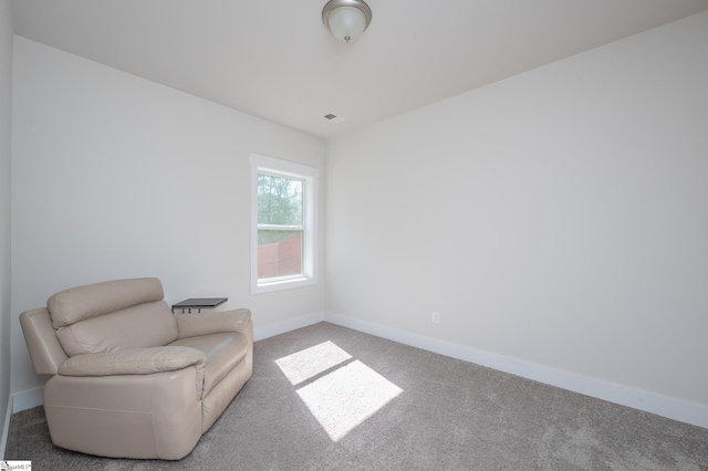 living area with carpet floors and baseboards