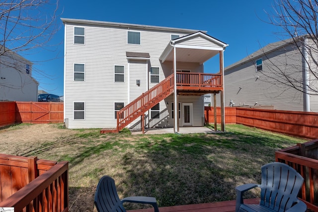 back of house with a patio, a lawn, a fenced backyard, a wooden deck, and stairs