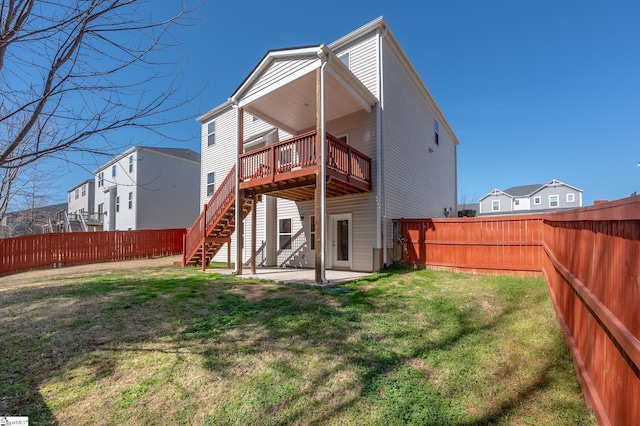 rear view of house with a patio, a lawn, stairway, a fenced backyard, and a wooden deck