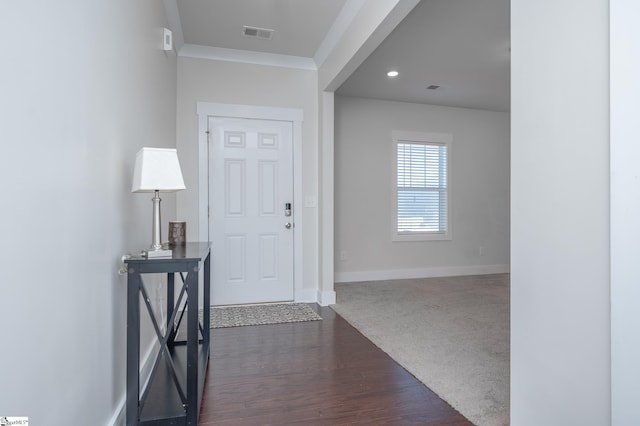 entrance foyer featuring baseboards, visible vents, dark wood-style floors, crown molding, and recessed lighting