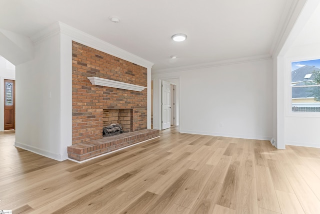 unfurnished living room with a brick fireplace, baseboards, ornamental molding, and light wood finished floors