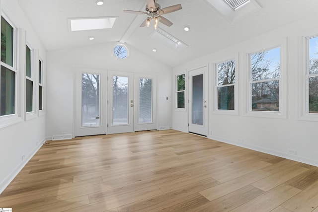 unfurnished sunroom with a healthy amount of sunlight, lofted ceiling with skylight, and visible vents