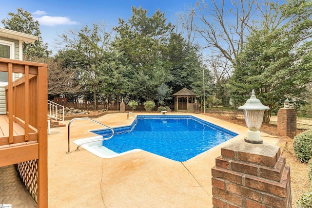 view of swimming pool featuring a patio area, a fenced backyard, a fenced in pool, and a gazebo