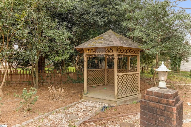 view of outbuilding featuring a gazebo and fence