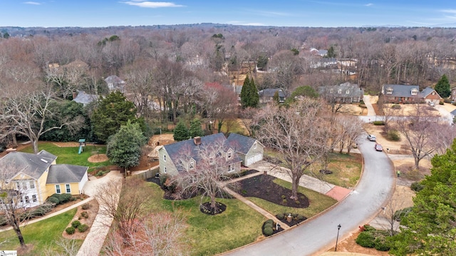 bird's eye view featuring a wooded view