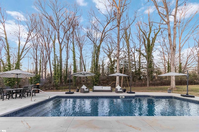 pool with a patio and fence