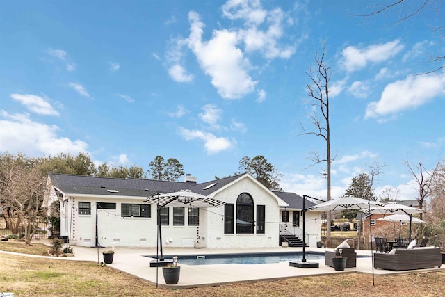 back of property featuring a chimney, a patio area, and an outdoor living space