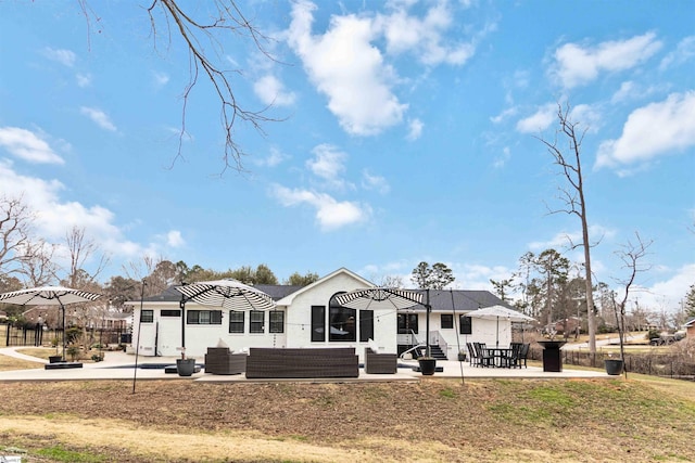 back of property featuring a patio area and an outdoor living space