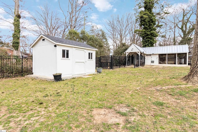 view of yard featuring a fenced backyard, a storage unit, and an outdoor structure