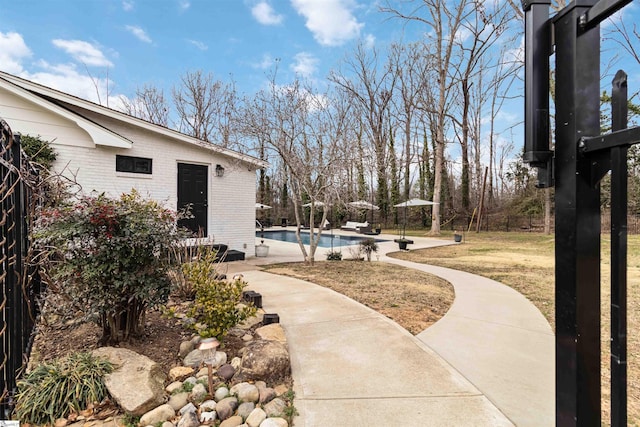 exterior space featuring fence and an outdoor pool