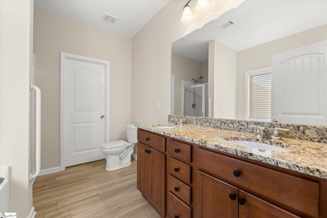 bathroom featuring a sink, visible vents, and a shower stall