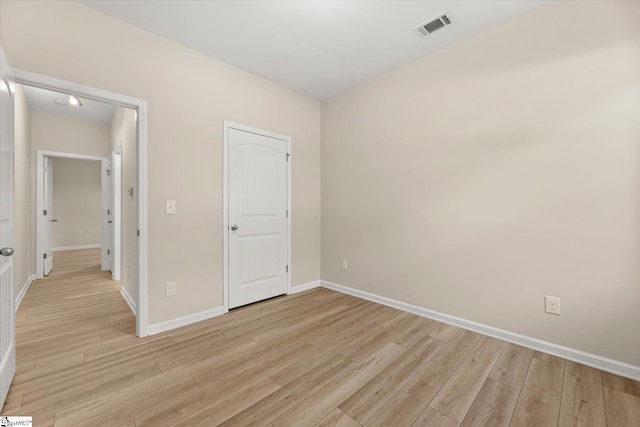 unfurnished bedroom featuring light wood-style floors, visible vents, and baseboards