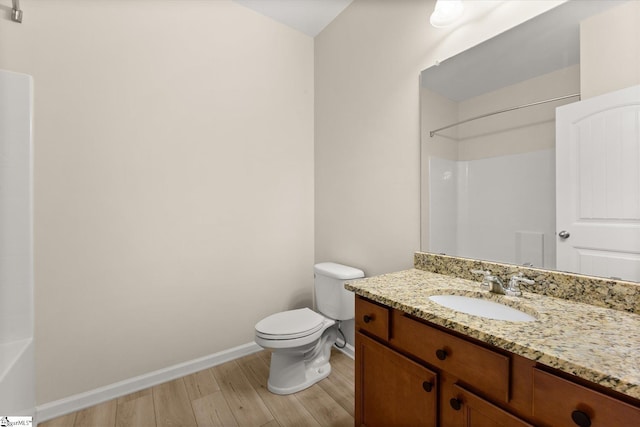 full bathroom featuring baseboards, vanity, toilet, and wood finished floors