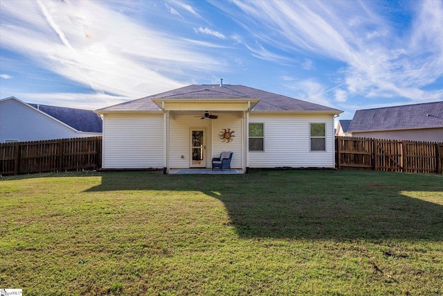 rear view of property with a yard, a fenced backyard, and ceiling fan