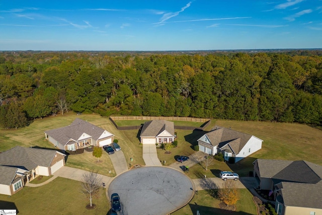 aerial view featuring a residential view and a wooded view